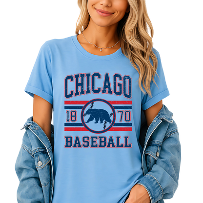 Woman wearing a light blue 'Chicago Baseball' t-shirt with a denim jacket and shorts on a white background